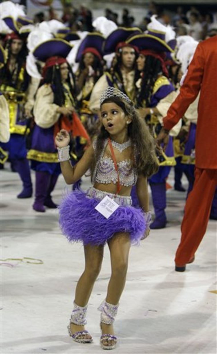 Julia Lira, 7, queen of the drums' section of Viradouro samba school, dances during carnival celebrations at the Sambadrome, in Rio de Janeiro, Monday, Feb. 15.